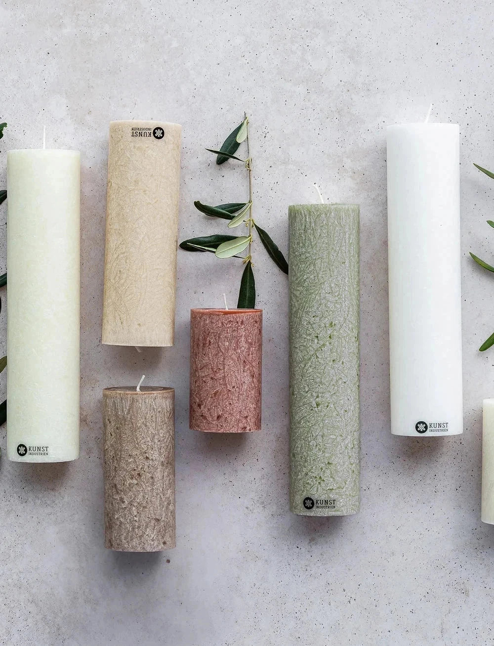 Kunstindustrien kubbelys 25 cm Moss Green i olivenvoks, sammen med flere lys i ulike farger og størrelser