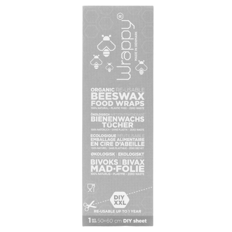 Grå pakke med Wrappy Bivokspapir DIY (50 x 60 cm). Gjenbrukbar, økologisk matoppbevaring av bomull, bivoks og jojobaolje. Klipp og tilpass størrelsen – reduser plastavfall og hold maten fersk