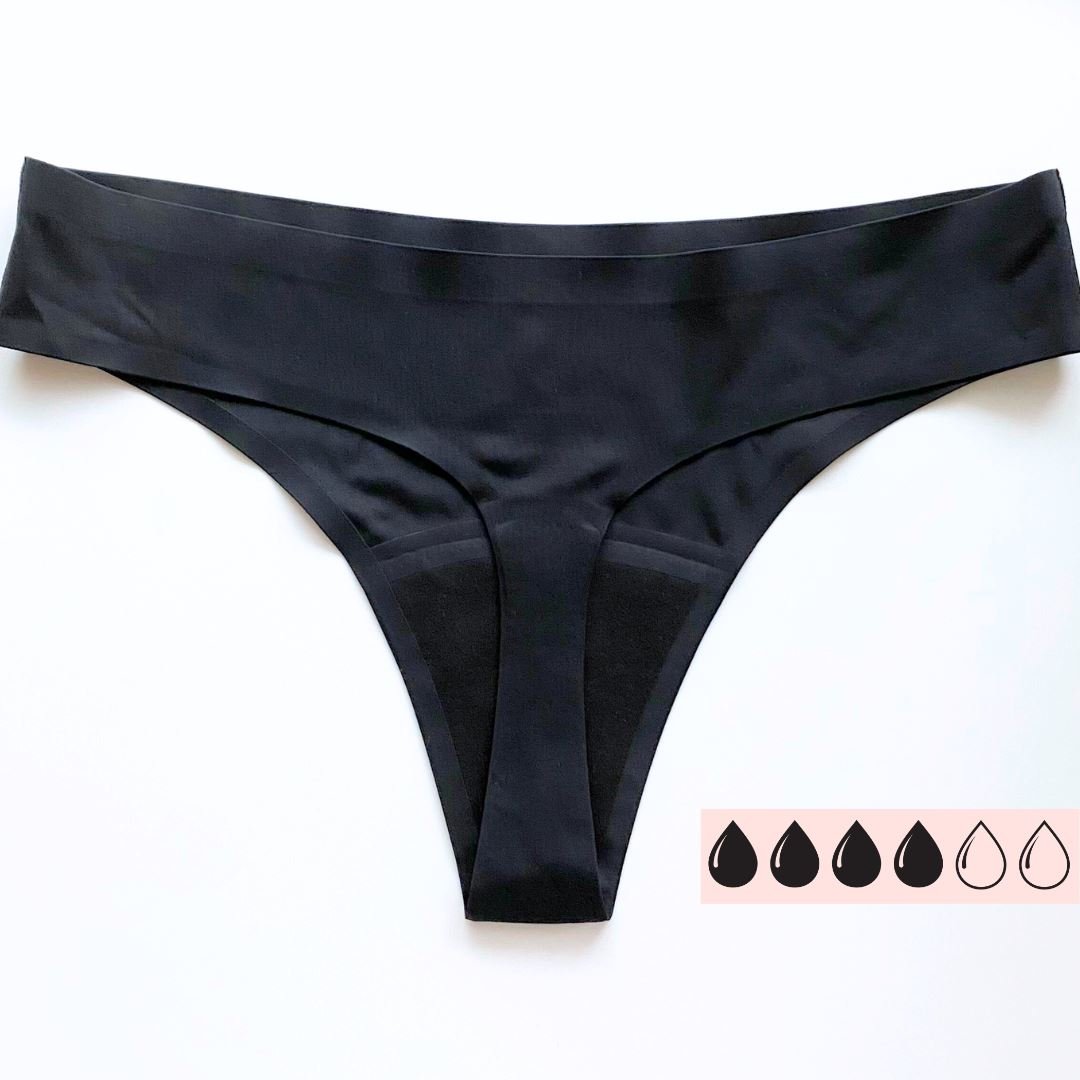 Comfydence Butterfly Menstruse Heavy Flow i svart polyester, sett ovenfra med absorberende innlegg synlig