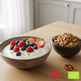 Suztain Økologiske Valnøtter 1 kg i brun farge i en svart skål ved siden av en skål med yoghurt og bær