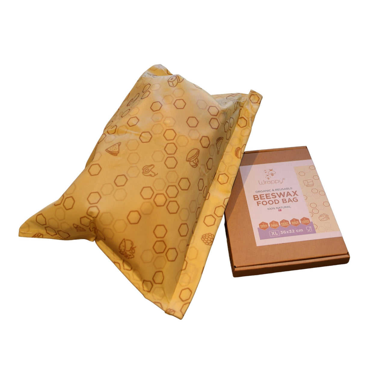 Wrappy bivoks matpose XL i gult bivokspapir, sammen med en naturfarget pappeske sett fra siden