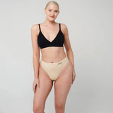 WUKA Stretch Thong for Light-Medium Flow i nude, i bruk på modell med svart BH, forfra